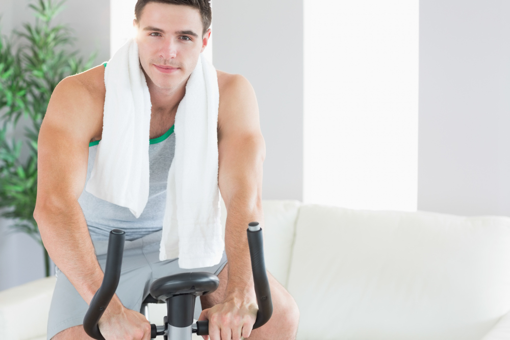 content handsome man training exercise bike